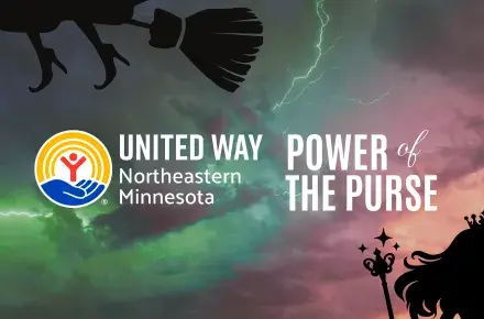 Green and pink lit sky with silhouettes of the wicked witch and Glinda. In foreground, UWNEMN Power of the Purse.