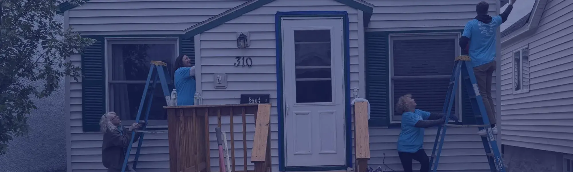 volunteers paint a house for Day of Action 