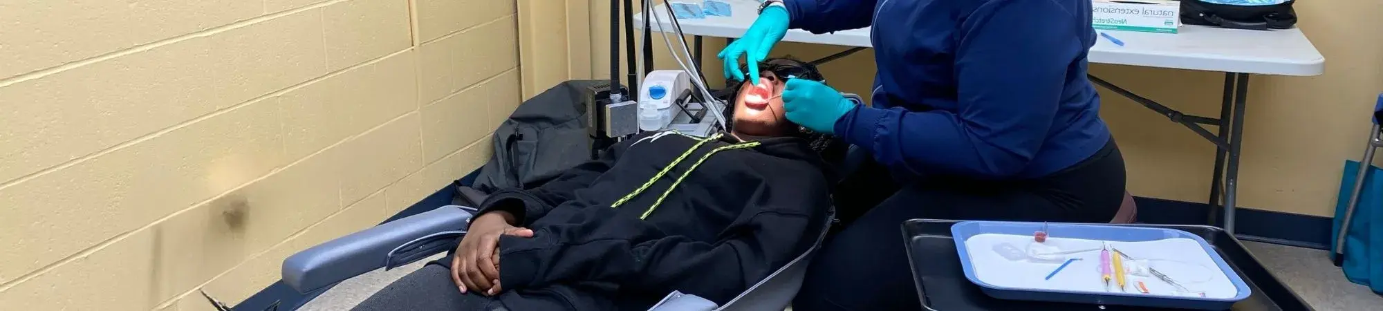 Smiles United patient receives dental care at UWNEMN's building