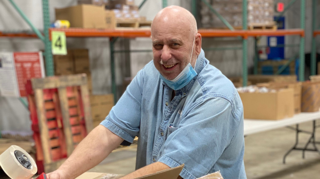 Craig Roberts builds Buddy Backpacks boxes at UWNEMN