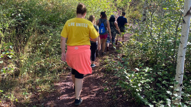 People walking in woods at Redhead MTB Park wearing Live United clothes.