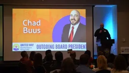 2025-2026 UWNEMN Board President Chad Buus speaks to a crowd at the organization's 60th annual celebration 