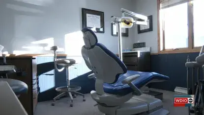 Dental chair in dental office; in lower right, WDIO logo