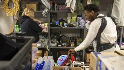 Tasha Mazzeo, left , shops as Antwon Johnson plays with their daughter Bella, 1, at theUnited Way's Comforts of Home program. Clint Austin / Duluth Media Group